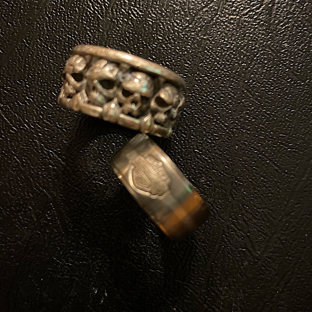 Two silver rings. Circular skulls. HD emblem. Sz 9.  1” circumference